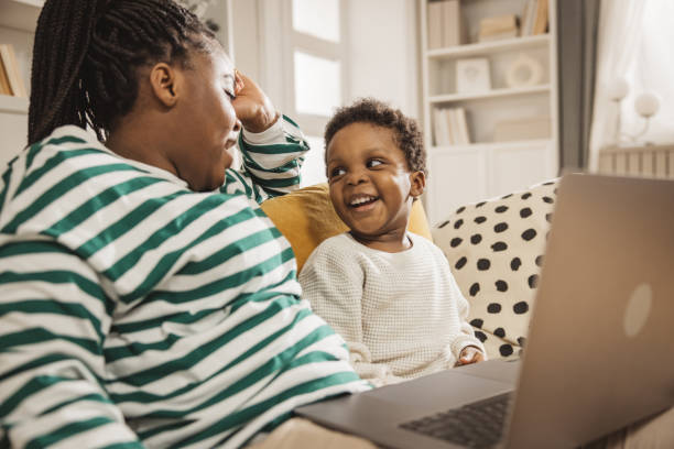 istock Mother and baby boy using laptop 1983606526