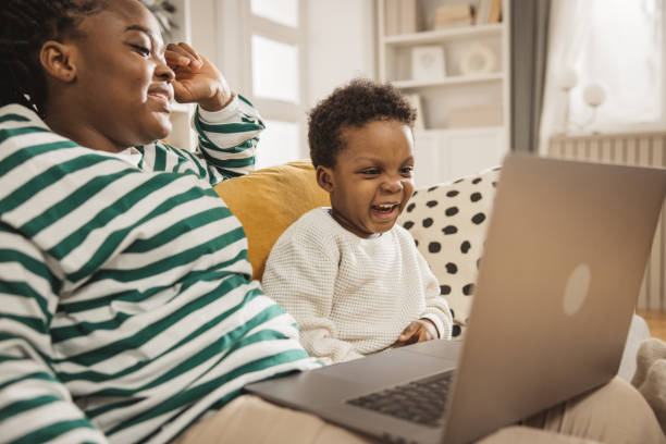 istock Mother and baby boy using laptop 1983607041