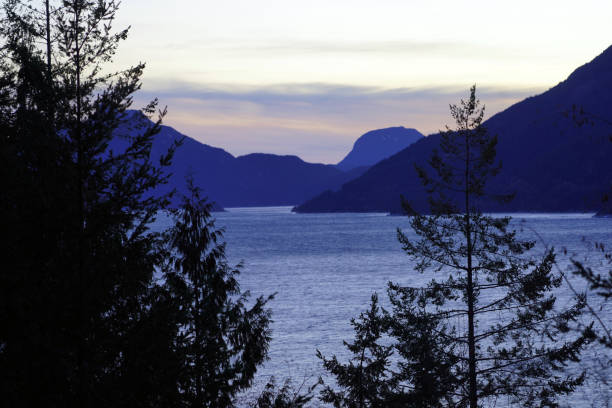 istock Ocean inlet backed by mountains n the early evening 1983607570