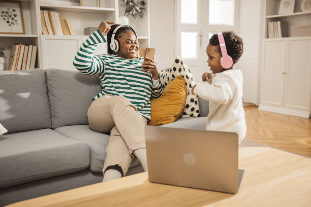 Dancing all day at home Mother filming with smart phone her baby boy while listening music and dancing. Wearing headphones. baby boy dancing with his mommy stock pictures, royalty-free photos & images