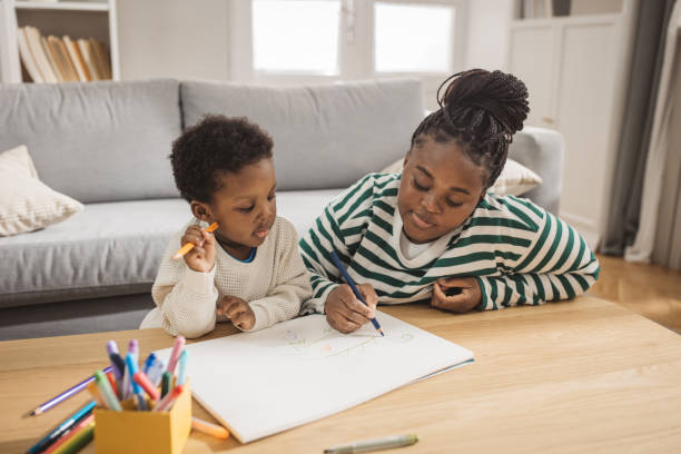 istock Mother and son coloring together 1983610689