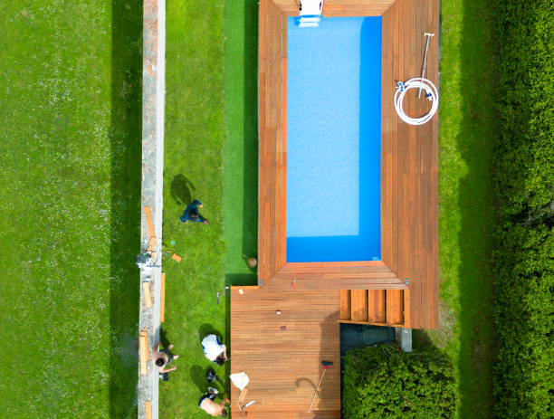 Unrecognizable people swimming in beautiful outdoors public pool, Podoli swimming complex, Prague, Czech republic