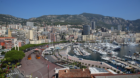 Yachts in bay near houses and hotels, La Condamine, Monte-Carlo, Monaco, Cote d'Azur, French Riviera.