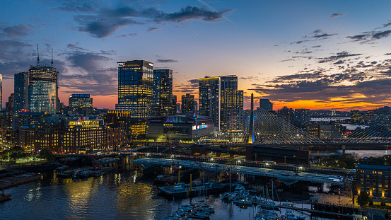 Marina Boston Harbor with a view of modern appartments and new house under construction at sunset.