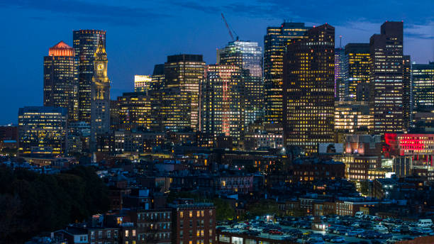 night illumination of harbor towers, custom house clock tower in downtown boston, ma. - boston aerial view charles river residential structure 뉴스 사진 이미지