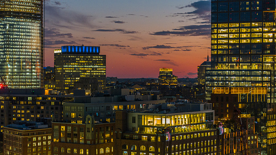 Construction of modern appartment and business district in Boston, MA at sunset.