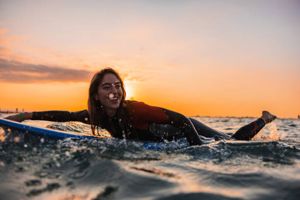 istock Adventurous Surfer Girl Practicing Her Surfing Skills At Sunrise 1983739831