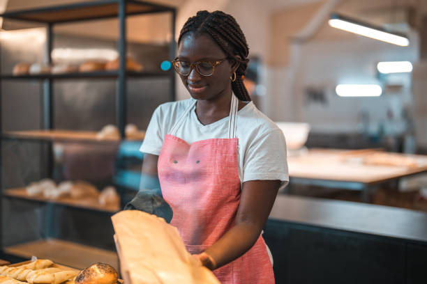 istock Black Female Shop Assistant In An Artisan Bakery 1983746327
