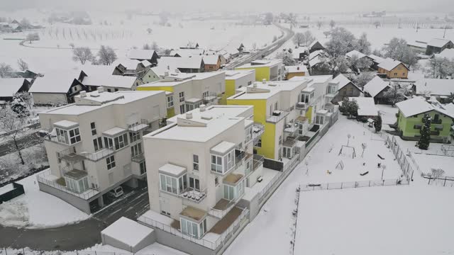 Modern apartment complex covered in snow on a cold winter day