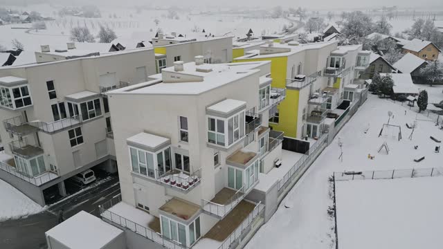 Aerial view of modern apartment buildings while a snow storm outside