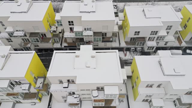 Roof tops of apartment complex covered in snow
