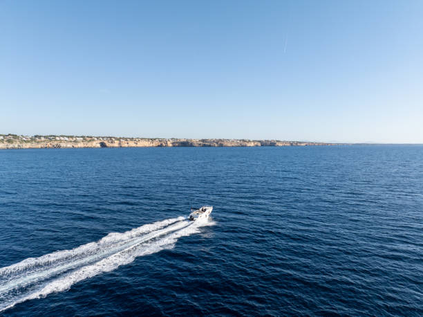 Zurrieq, Malta - 18 June 2023: Boat full of tourists transported in Luzzu to the Blue Grotto, Malta.