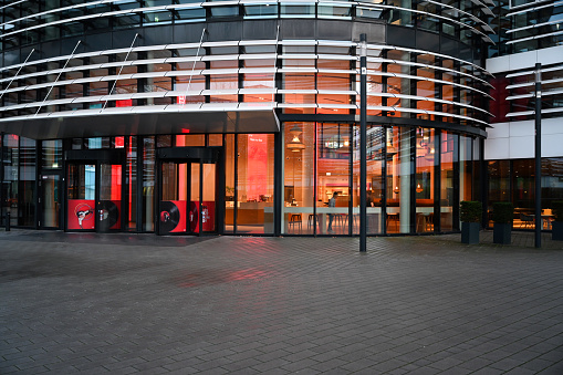 Modern office building with glass walls just after sunset in Helsinki, Finland.