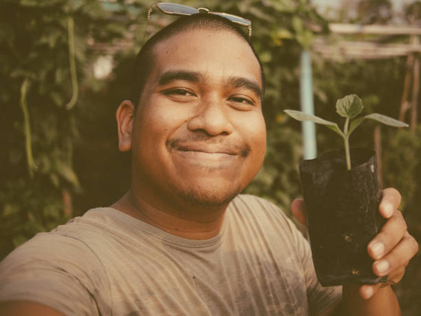 istock man carry new plant 1983859527