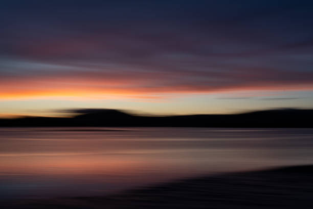 istock Background sunset intentional camera movement effect soft hues on morning light blue hour. 1983908173