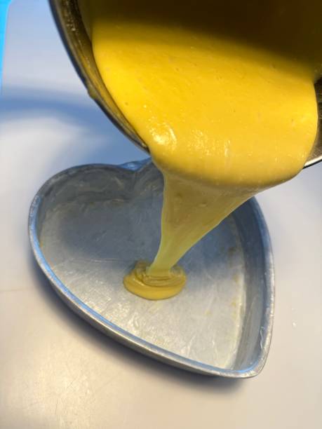 istock Pouring yellow cake batter into a mold 1983918816