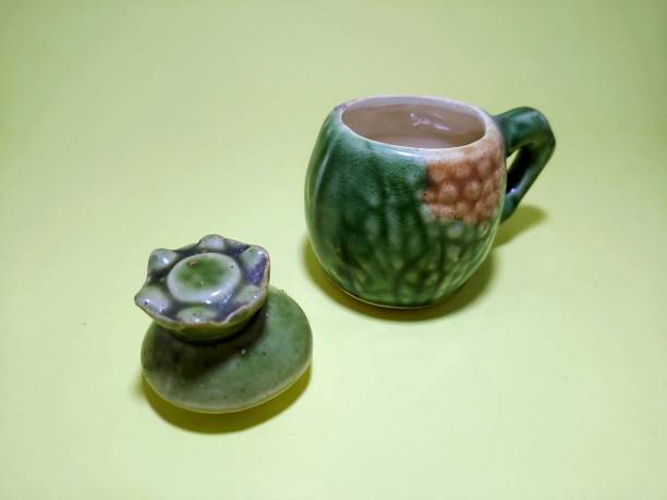 istock Green porcelain cups on a yellow background 1984035727