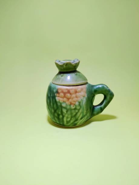 istock Green porcelain cups on a yellow background 1984037833