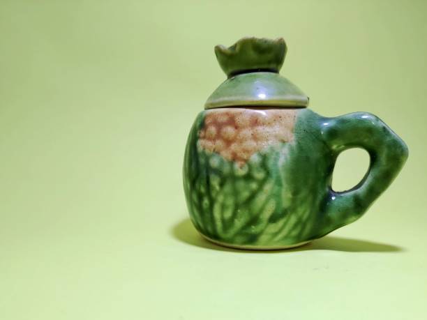 istock Green porcelain cups on a yellow background 1984037834