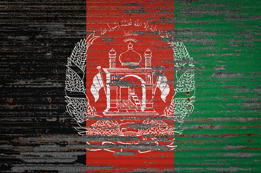 Close-up of old metal wall with national flag of Afghanistan. Concept of Afghanistan export-import, storage of goods and national delivery of goods. Flag in grunge style