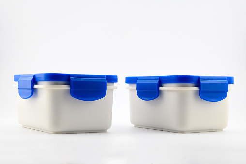 two white food plastic containers with blue lid for lunch, close up side view on white background