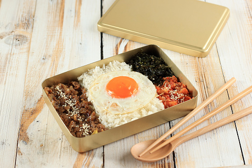 Dosirak, Korean Style Packed Meal or Korean Lunchbox. Usually Use Gold Metal Box, Easy to Heat Up. Rice with Bulgogi, Kimchi, Sunny Side Egg, and Roasted Laver