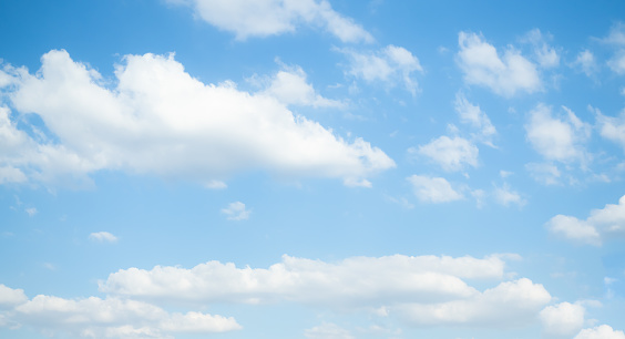 Cirrus clouds appear in a blue sky over Walnut Canyon Lakes in Flagstaff, Arizona, USA.