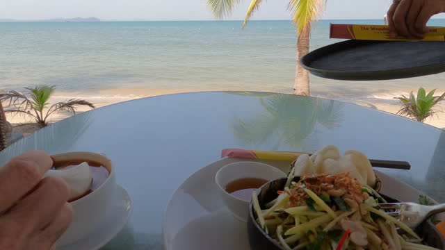 Personal perspective of enjoying healthy meal, beach