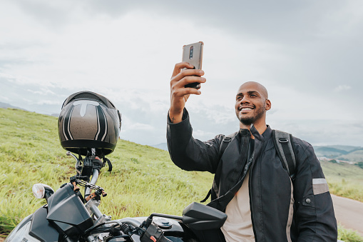 Motorcyclist pausing to take a photo of the countryside