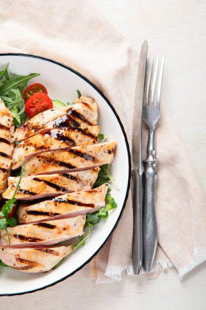 istock Roasted chicken breast, fillet and fresh vegetable salad. 1984263329