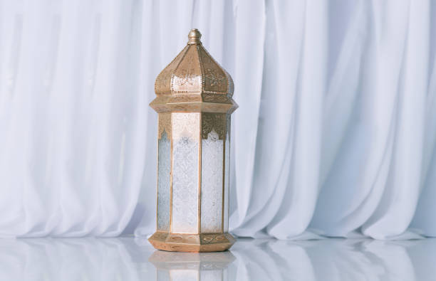 Lantern with burning candle isolated on white background.