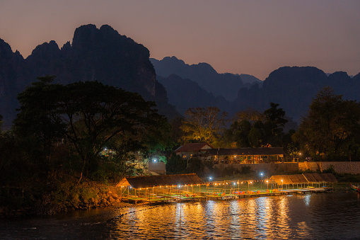Illuminated riverbank of Mekong river with small cafes and bars at night