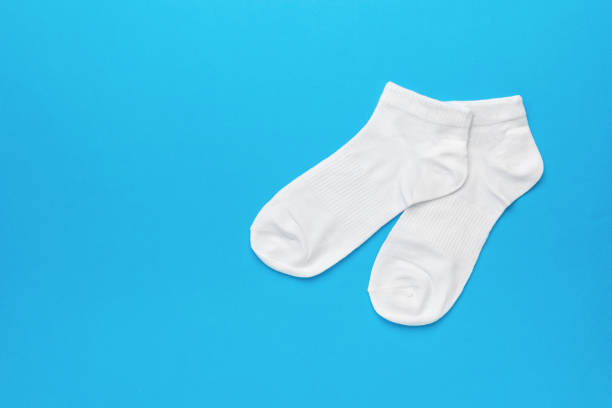 istock A pair of elegant white socks on a blue background. 1984316889