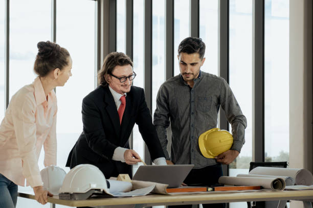istock Engineer team is meeting to inspect the construction blueprint drawings, work plan and distribute work before starting the building 1984368984