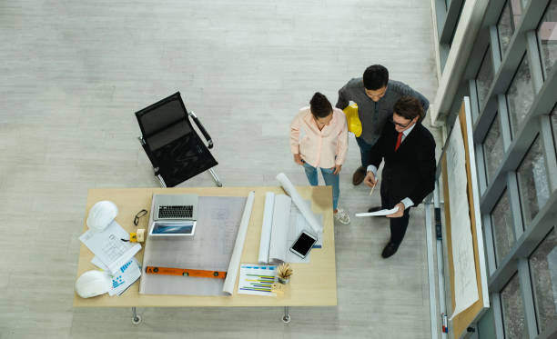 istock Engineer team is meeting to inspect the construction blueprint drawings, work plan and distribute work before starting the building 1984369516