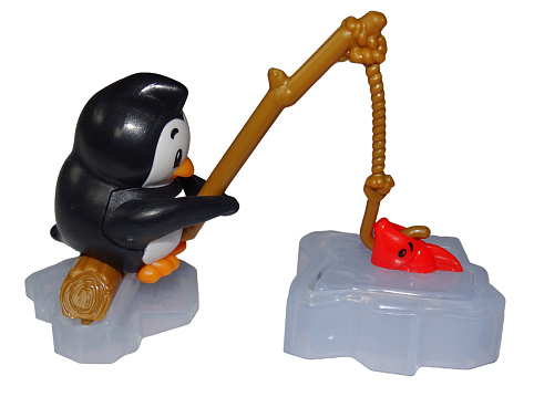 Children's toys: Scene with a penguin catching fish