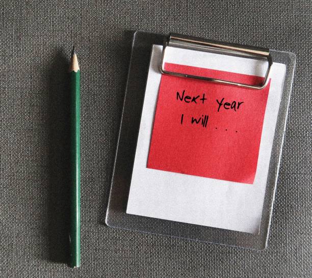 istock Pen on note paper with text written NEXT YEAR I WILL and blank list - concept of goal setting , identify what is short term goals to achieve for the next coming year 1984417722