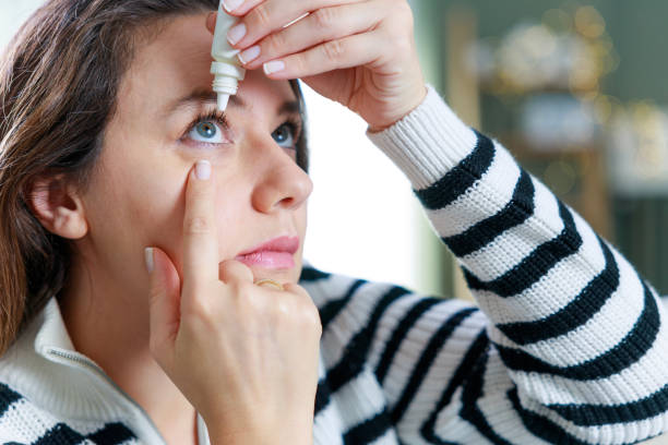 istock Young woman putting eye drops 1984440097
