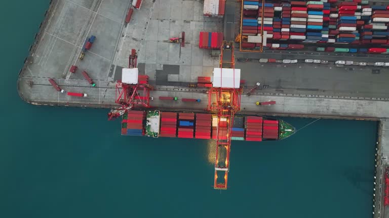 Aerial view of a container ship loading and unloading cargo in the port.