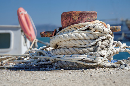 Ropes and rope ladder on a sailing ship with cloudy sky in the background