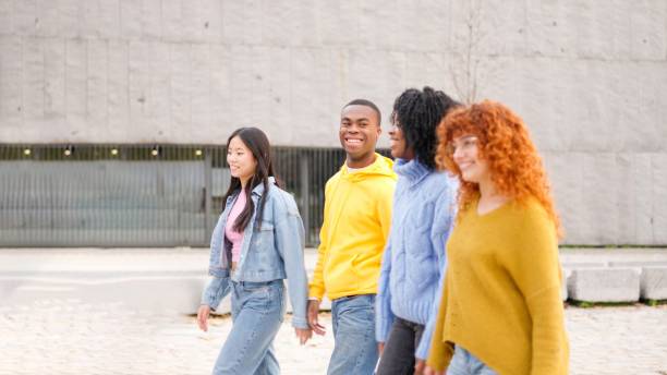 istock Friends smiling while strolling along the street 1984460455