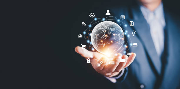 istock Businessman holding virtual world with icons and connection line for data exchange from globalization innovation technology and global business concept. 1984473082
