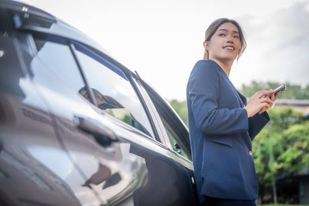 istock On-the-Go Glamour: When Fashion and Tech Unite by the Car Side 1984476677