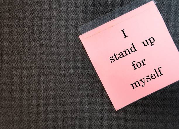 istock Stick note on copy space wallpaper with handwritten text I STAND UP FOR MYSELF, positive daily affirmation to boost self esteem - uplift and powerful self talk statement to feel empowered and confident 1984487123