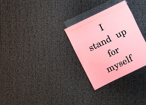 Stick note on copy space wallpaper with handwritten text I STAND UP FOR MYSELF, positive daily affirmation to boost self esteem - uplift and powerful self talk statement to feel empowered and confident