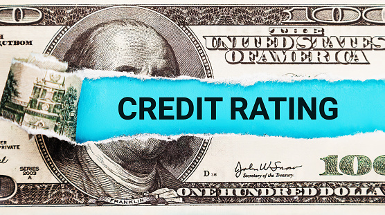 Credit Rating. The word Credit Rating in the background of the US dollar. Financial Trustworthiness and Creditworthiness Evaluation Concept.