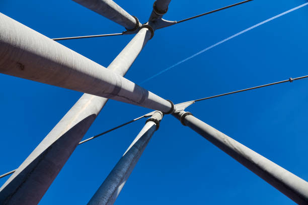 Abstract of arch bridge cables and cumulus clouds. Engineering details of Broadway street arch bridge over the Arkansas river in Little Rock.