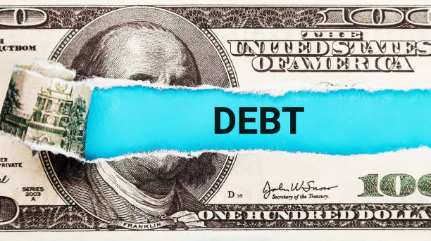 Debt. The word Debt in the background of the US dollar. Financial Burden, Loan, and Credit Concept. Stress from Financial Obligations Debt. The word Debt in the background of the US dollar. Financial Burden, Loan, and Credit Concept. Stress from Financial Obligations. debt recovery stock pictures, royalty-free photos & images