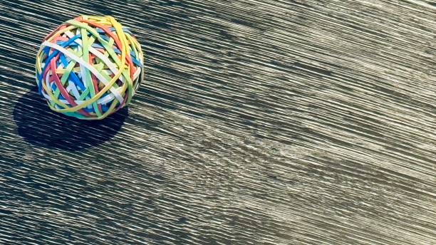 Various colorful handmade hanging ornaments made of threads and beads are beautifully displayed in the market, showcasing traditional craftsmanship and vibrant art from Pushkar, Rajasthan, India, during the Camel Fair.