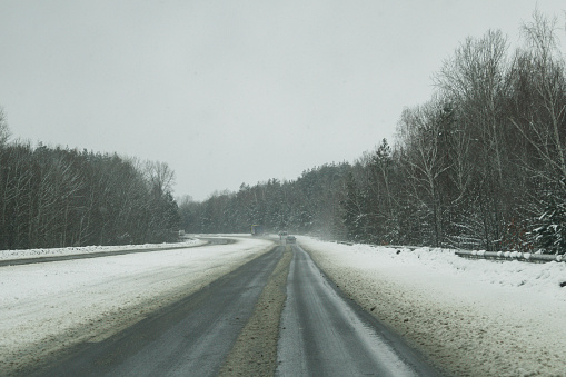 Kyiv, Ukraine - February 3, 2024. It is snowing heavily on the street, the roads are covered with snow. beautiful snowy forest and fields. the road from Kyiv to another city. fabulous views of the forest and fields